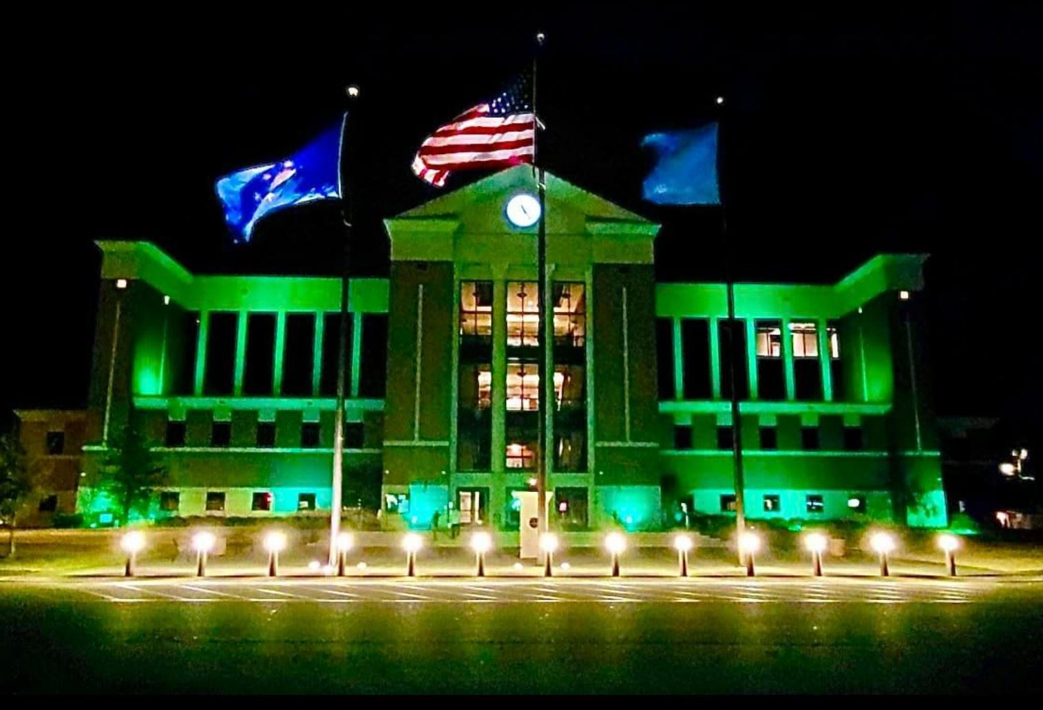 photo of courthouse lit green honoring our veterans
