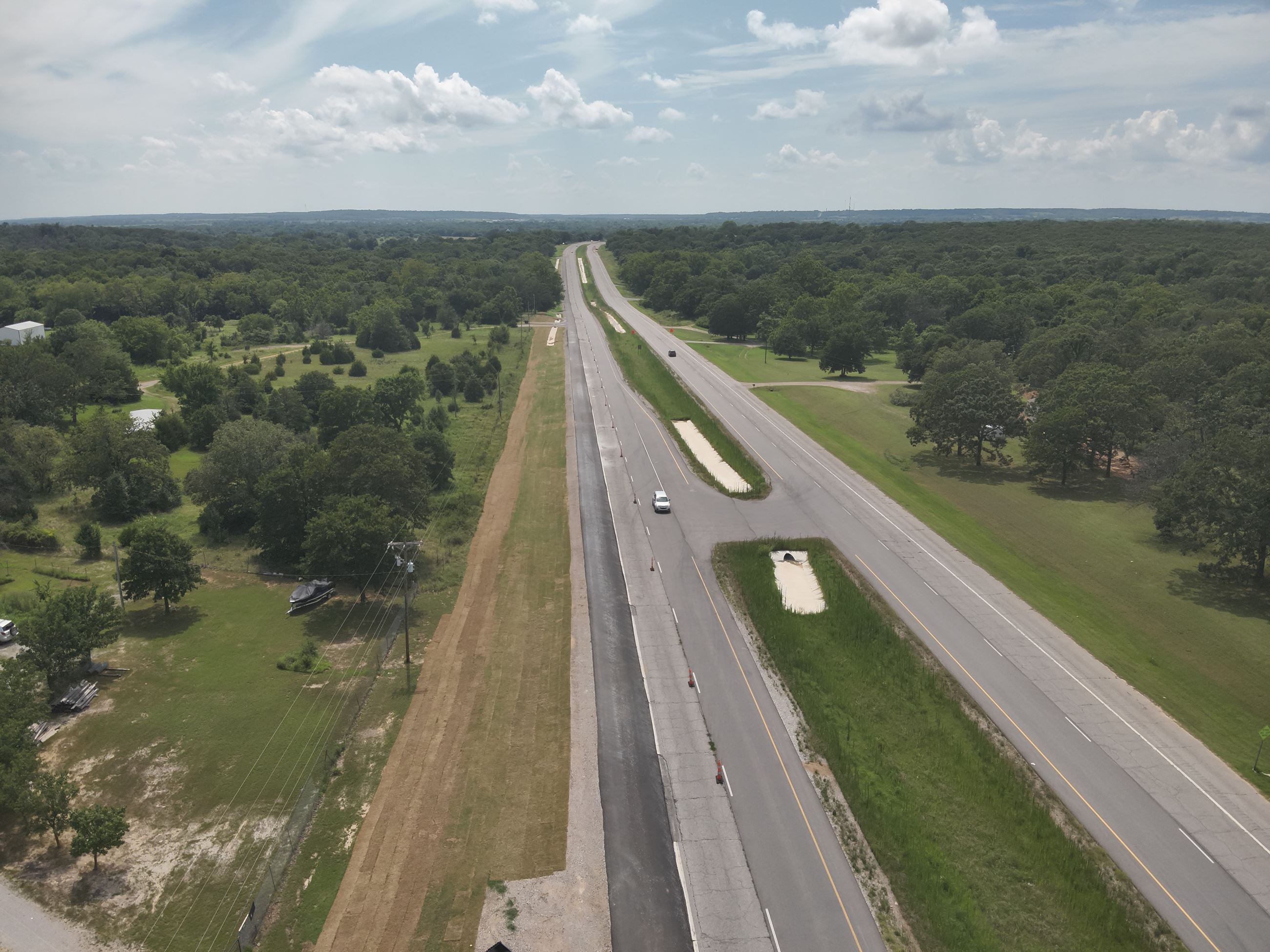 Shows highway work in District 1 road pavement and greenery