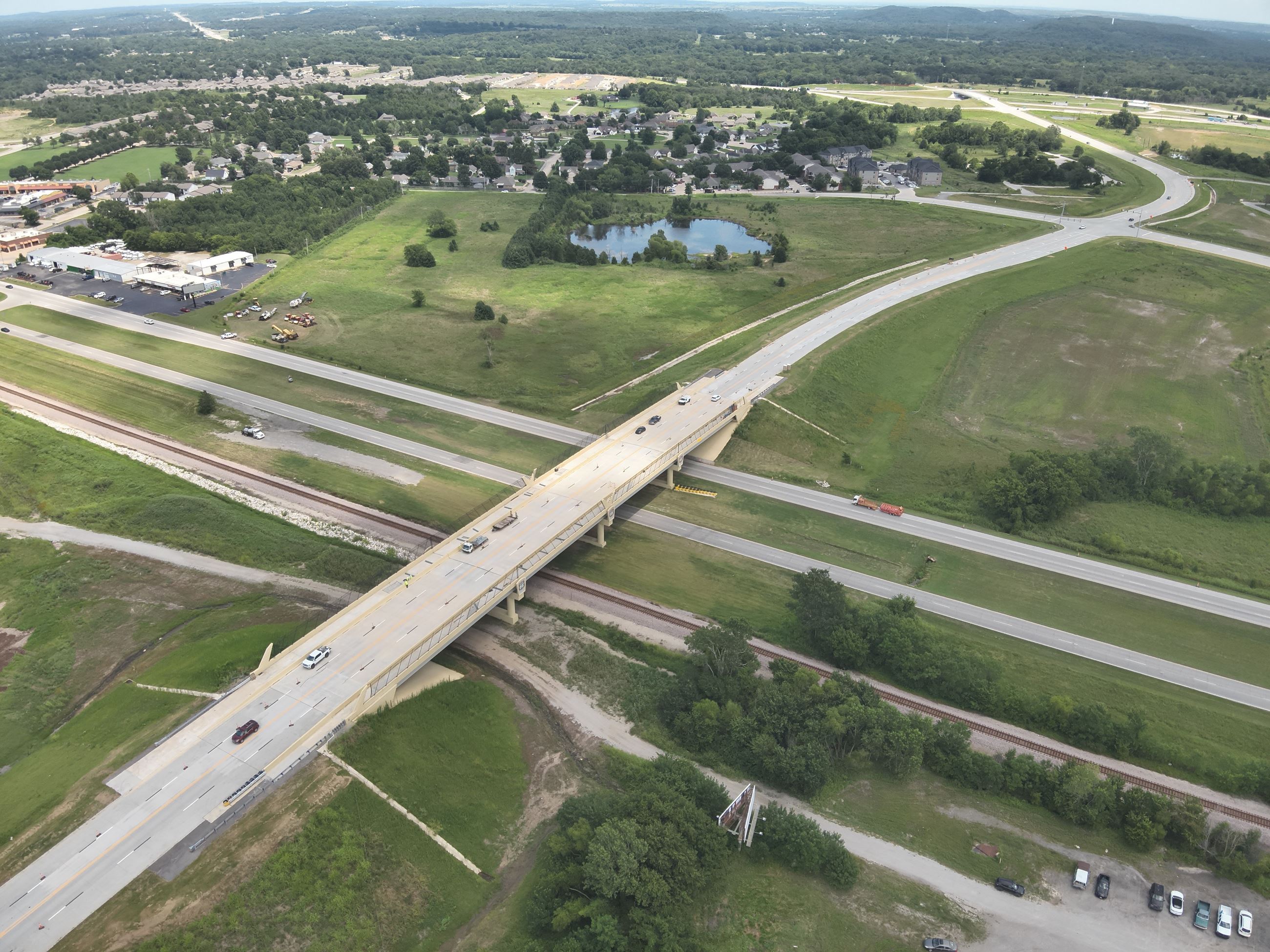 SH-20 Bridge showing fencing that is going up colors off-white, tan and green