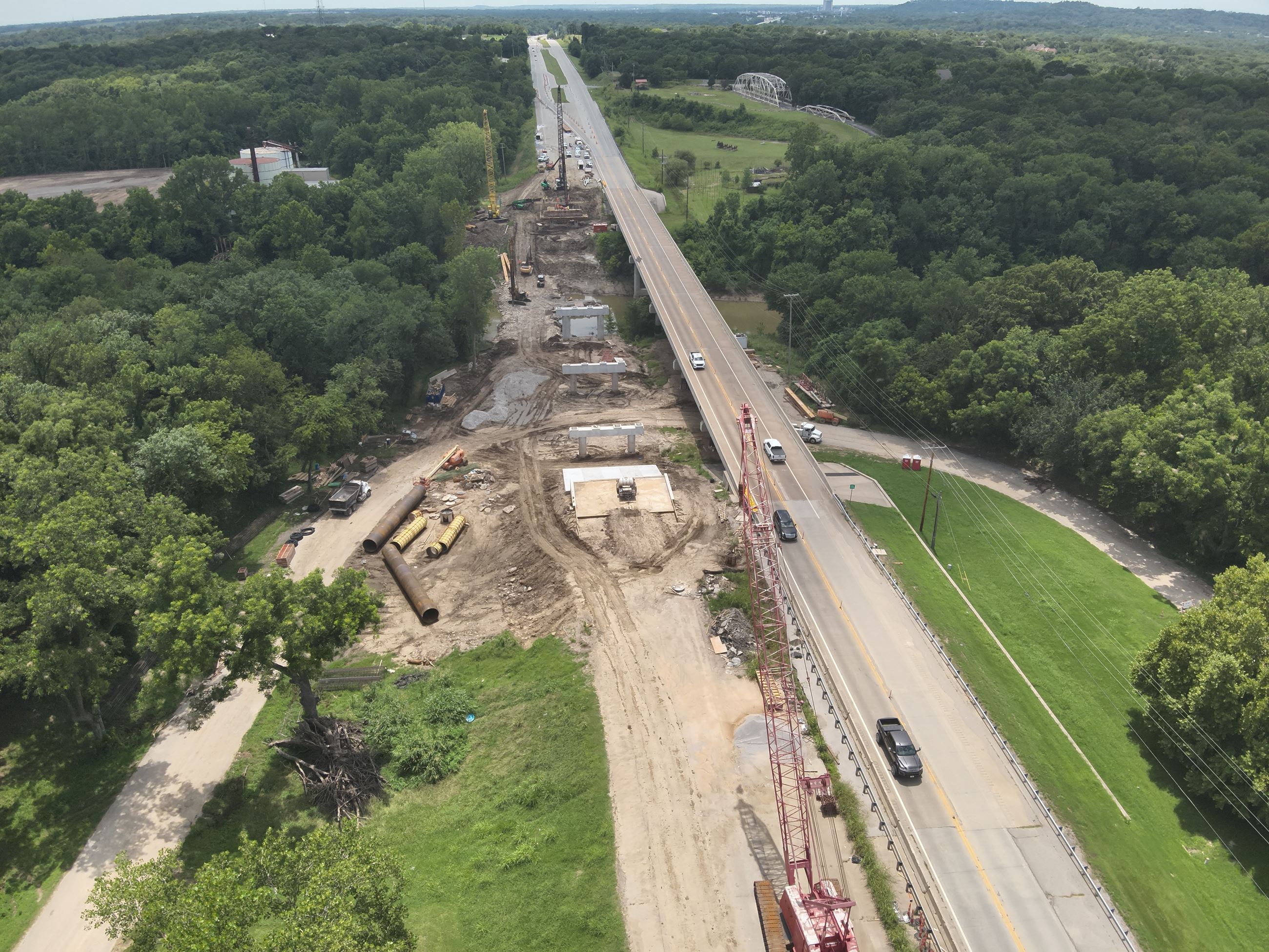 Verdigris bridge replacement project with tan and green colors
