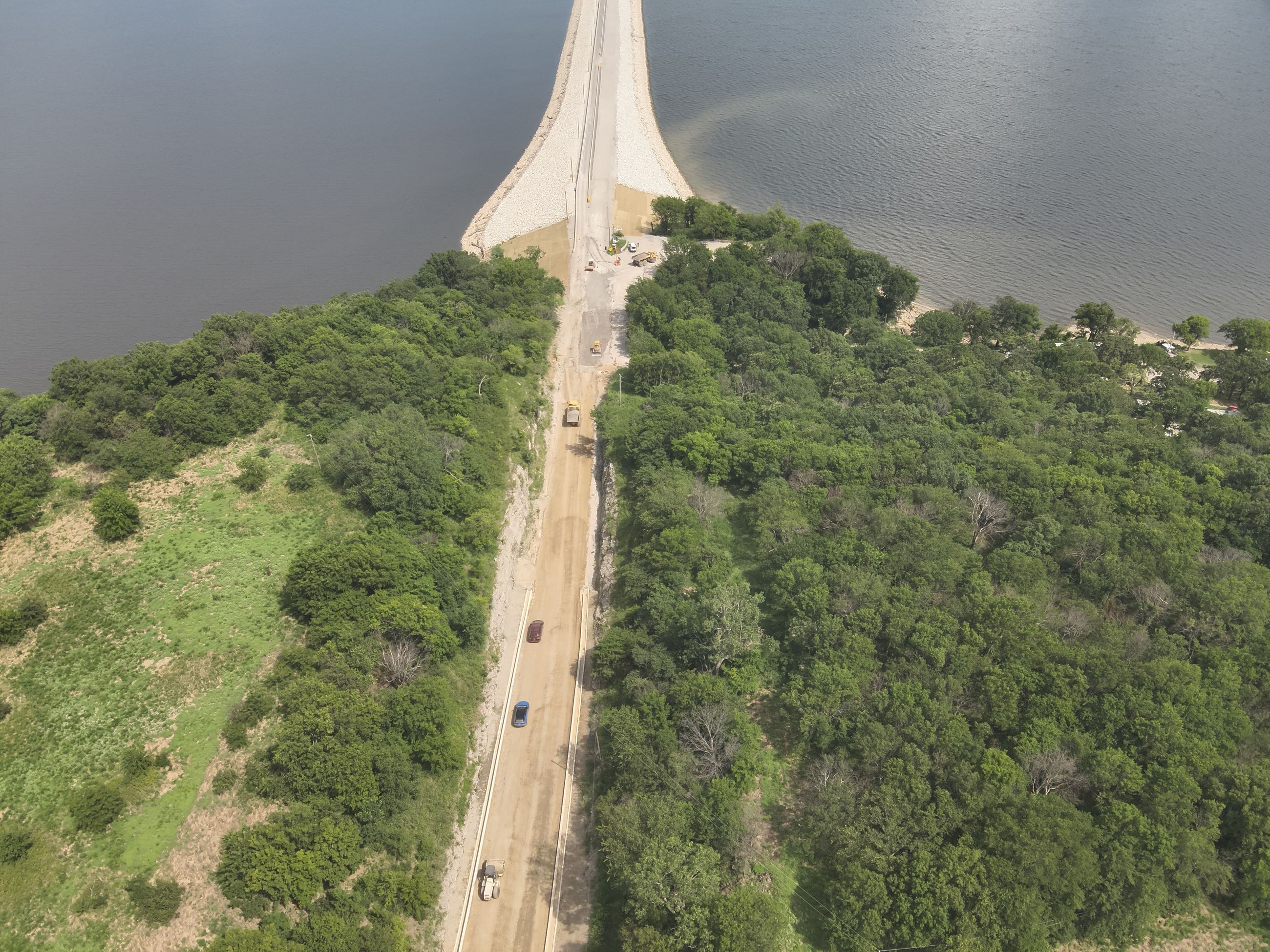 Winganon Causeway shows bluish water, dirt road and green land
