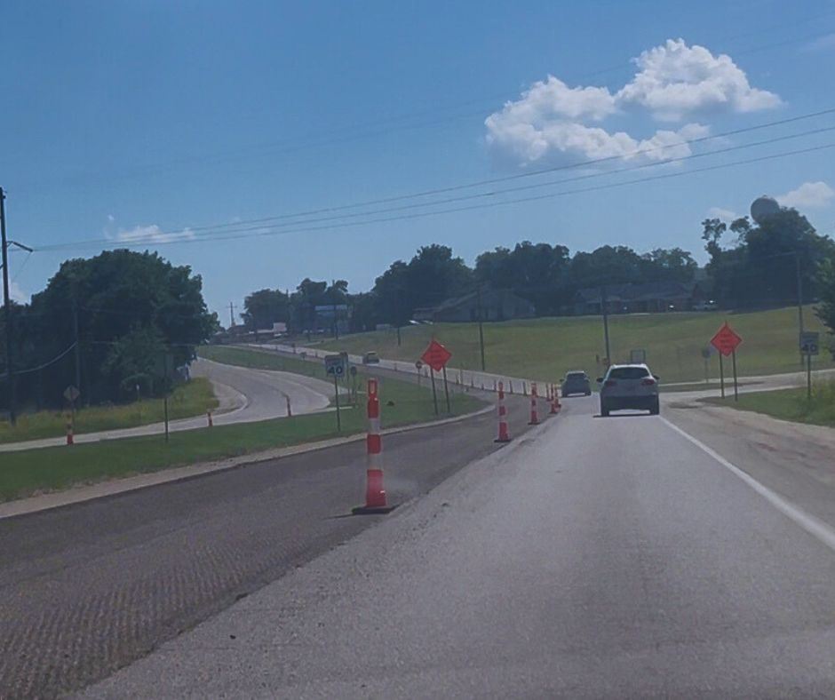 Shows black highway with greenery Catoosa SH-66 resurfacing